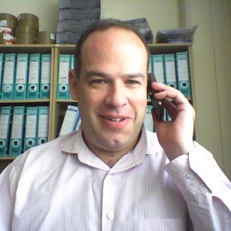 A professional business portrait of Alan David Smith.